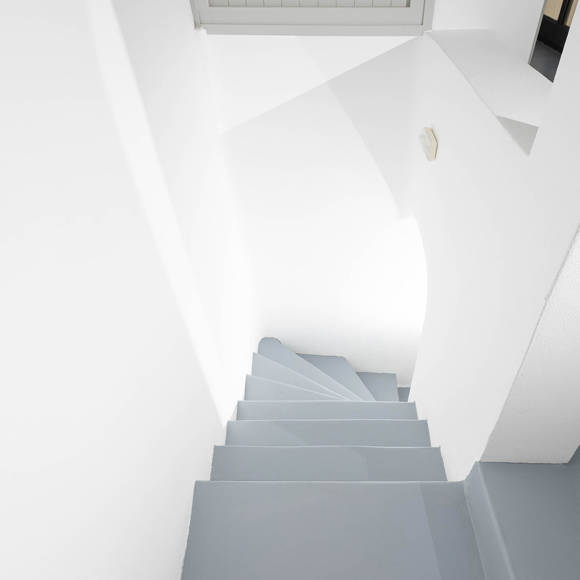Grand Ambassador Santorini Serenity Two Bedroom Suite interior white staircase with minimalist Cycladic design