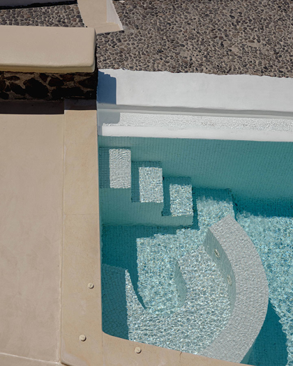Private villa pool with curved steps at Grand Ambassador hotel, Santorini