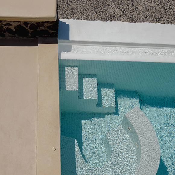 Private villa pool with curved steps at Grand Ambassador hotel, Santorini