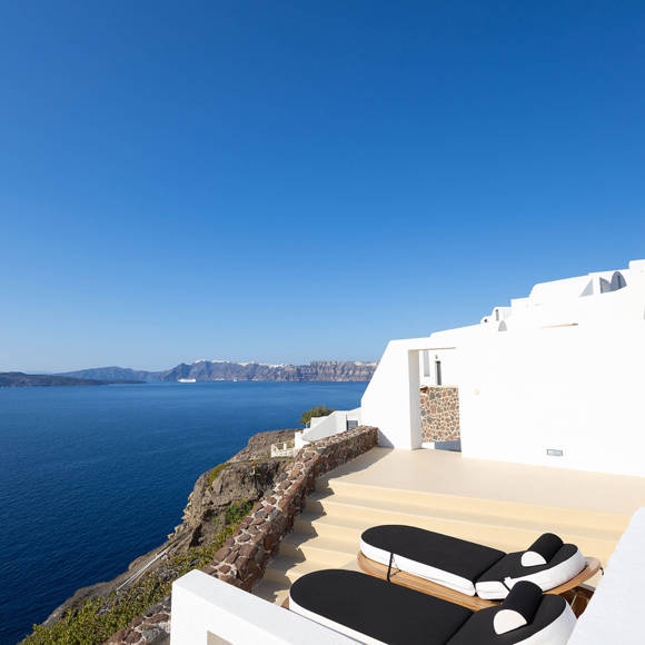 Grand Ambassador Santorini Serenity Two Bedroom Suite private terrace with designer sun loungers and panoramic caldera views